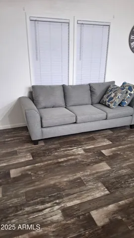 a kitchen with stainless steel appliances a refrigerator a stove a sink and a dining table with wooden floor