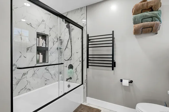 a bedroom with furniture and a flat screen tv