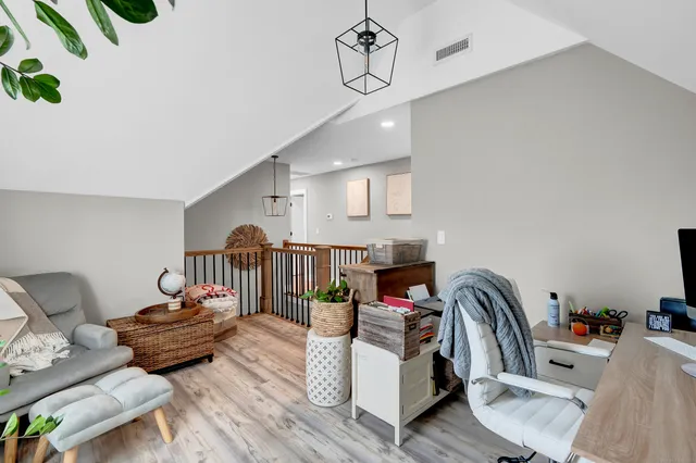 a room that has a bed and a chair in it