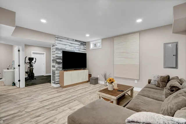 a front view of house with yard and trees in the background