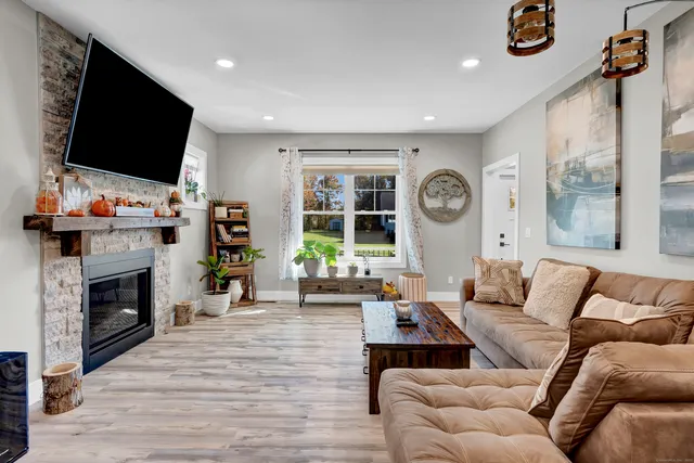 a living room with fireplace furniture and a flat screen tv