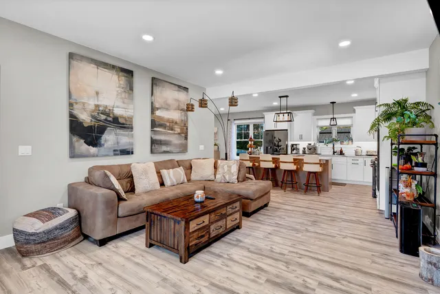 a kitchen with cabinets a sink stainless steel appliances and dining table