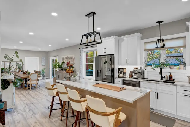a dining room with furniture and wooden floor