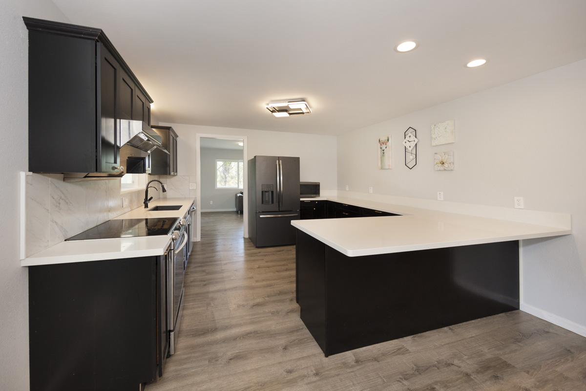 11-2420 Ohialani Road Mountain View, HI 96771 - Photo 11 of 30 a kitchen with a sink refrigerator and cabinets