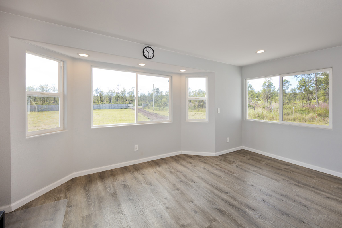 11-2420 Ohialani Road Mountain View, HI 96771 - Photo 14 of 30 a view of an empty room with wooden floor and a window