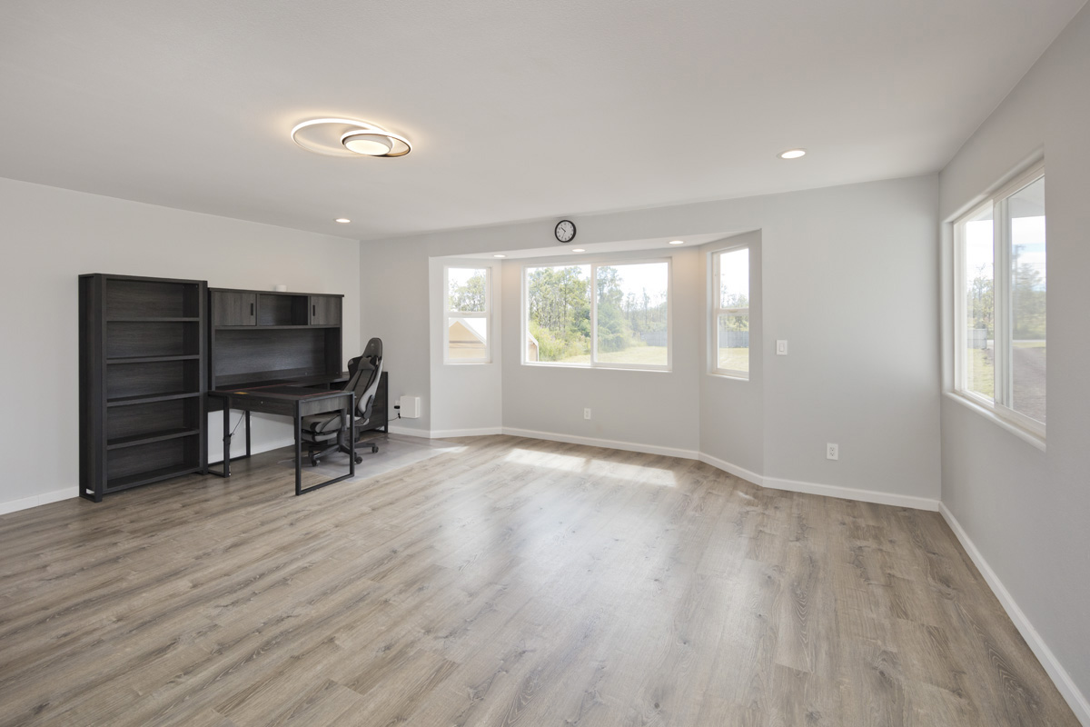 11-2420 Ohialani Road Mountain View, HI 96771 - Photo 15 of 30 an empty room with windows wooden table and chair