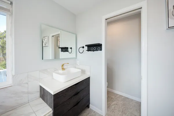 a bathroom with a sink and a mirror