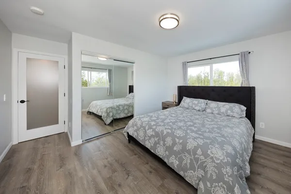 a bedroom with double bed and a window
