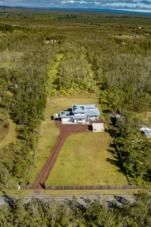 a view of a house with pool and ocean view