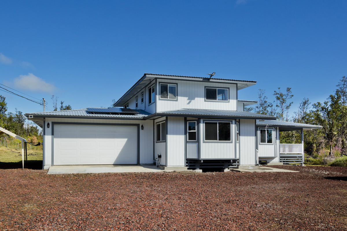11-2420 Ohialani Road Mountain View, HI 96771 - Photo 3 of 30 a front view of a house with a yard and garage