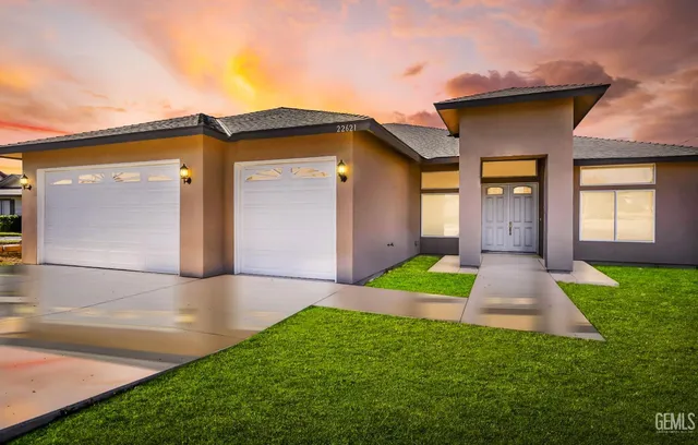 a front view of a house with garden