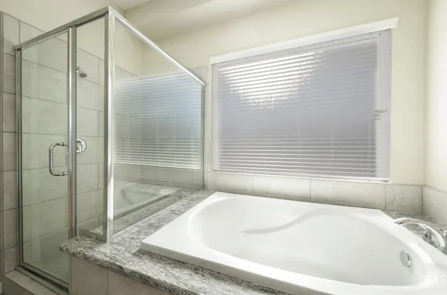 a bathroom with a bathtub and shower
