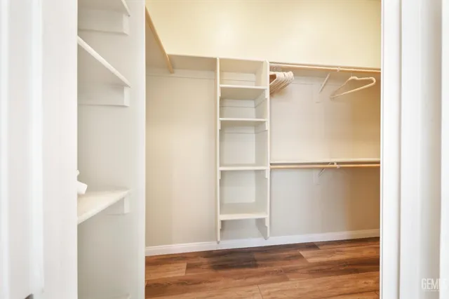 a view of walk in closet with empty racks