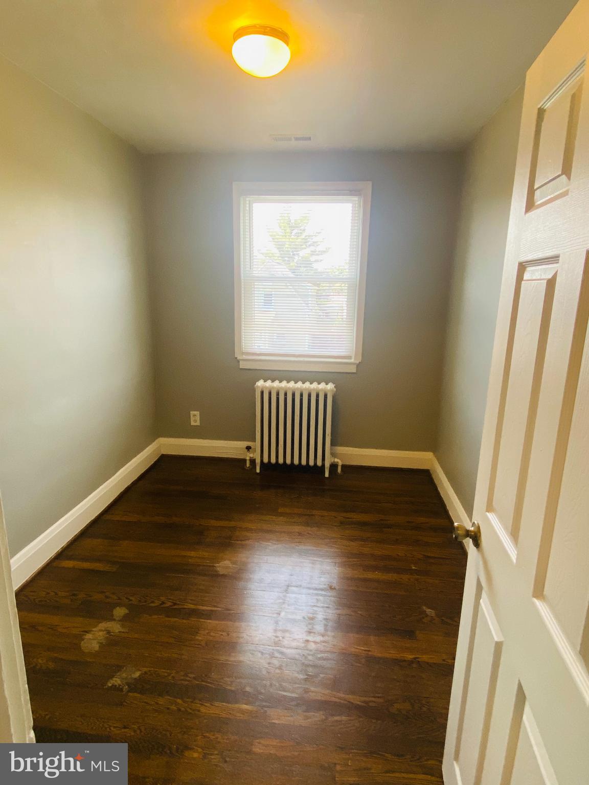2504 Liberty Parkway Dundalk, MD 21222 - Photo 11 of 21 a view of an empty room with wooden floor and a window