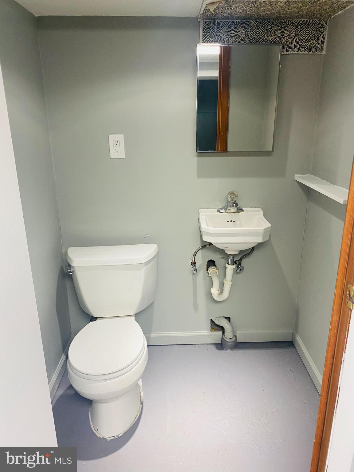 2504 Liberty Parkway Dundalk, MD 21222 - Photo 13 of 21 a bathroom with a toilet sink and mirror