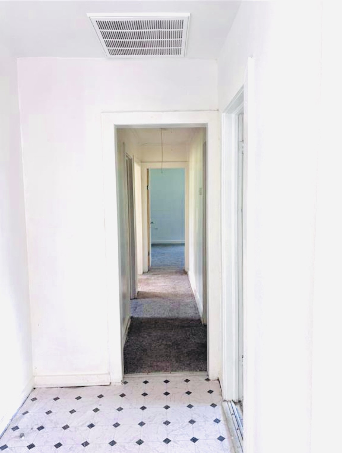 1314 Sabine Street Orange, TX 77630 - Photo 5 of 9 a view of a hallway view with wooden floor and a white cabinet