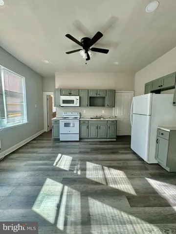 a view of a kitchen with a sink dishwasher and a refrigerator