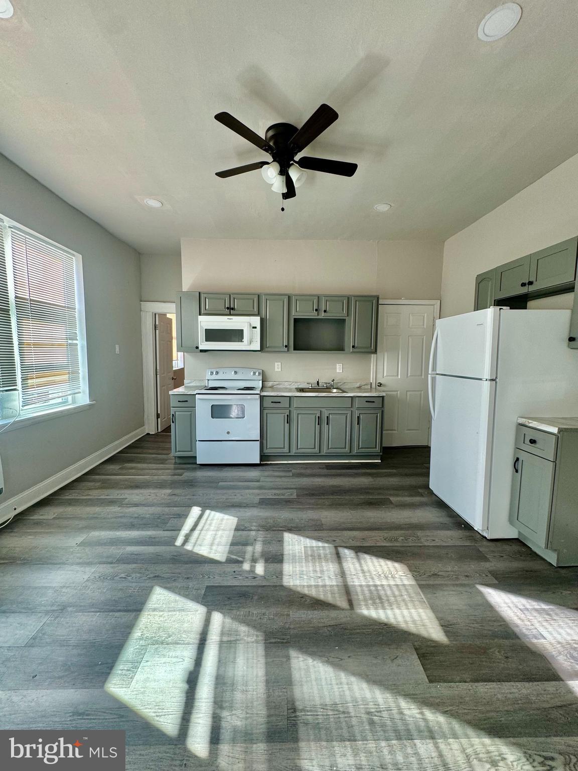 4818 North 13th Street, Unit 1 Philadelphia, PA 19141 - Photo 2 of 12 a view of a kitchen with a sink dishwasher and a refrigerator