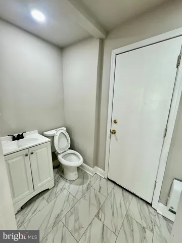 a white toilet sitting next to a bathroom sink