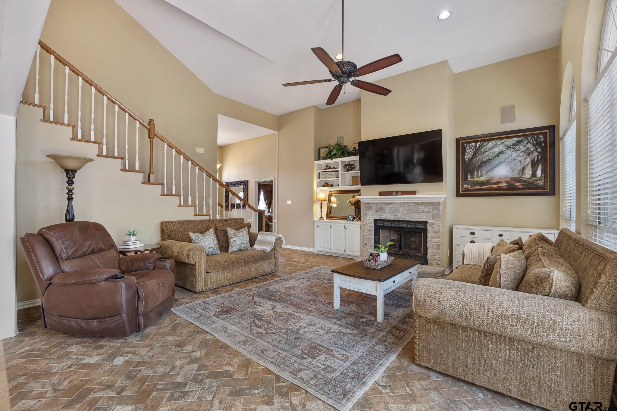 18344 Springmill Court Flint, TX 75762 - Photo 12 of 45 a living room with furniture a flat screen tv and a fireplace