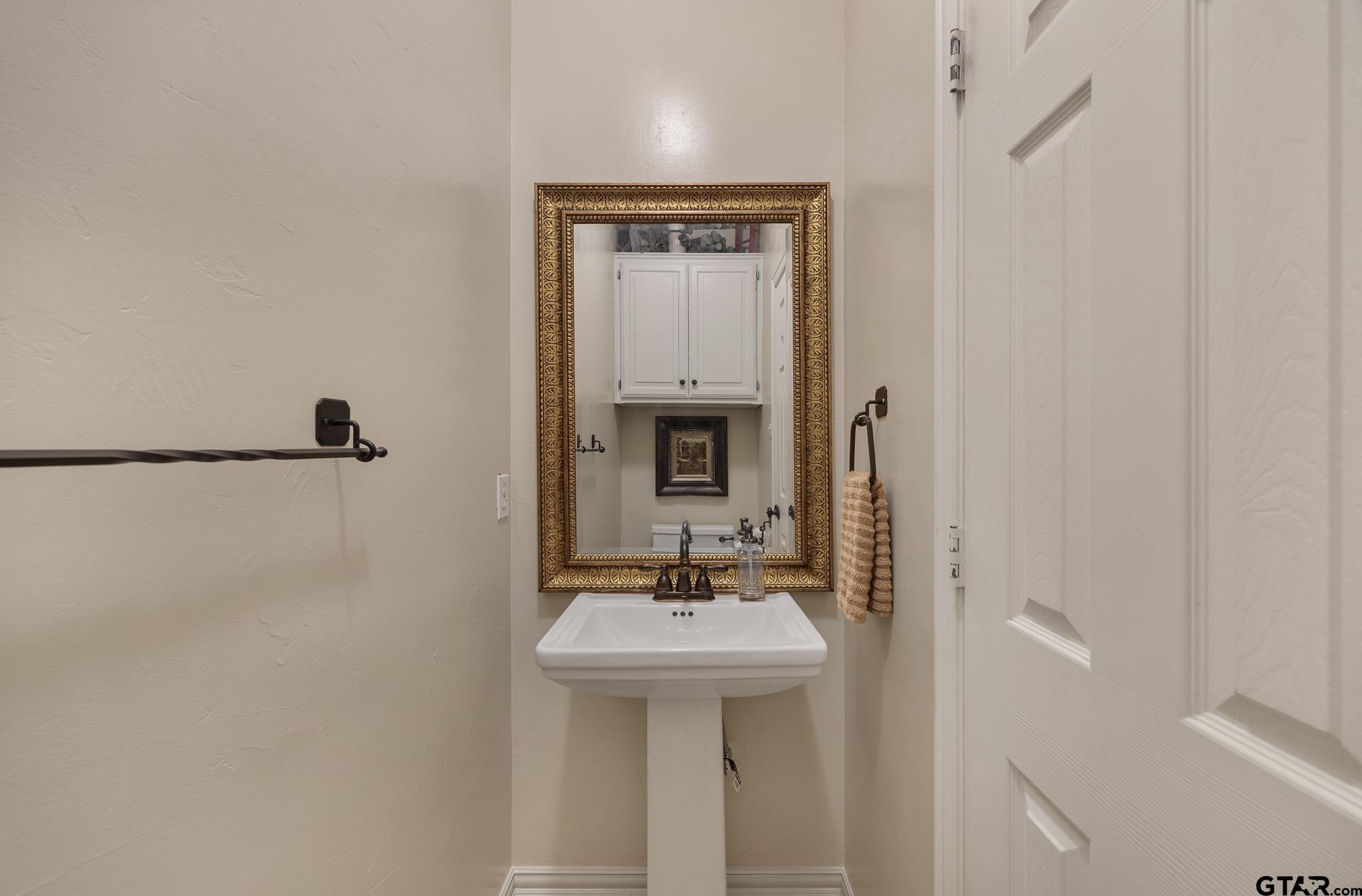 18344 Springmill Court Flint, TX 75762 - Photo 22 of 45 a bathroom with a sink and a mirror