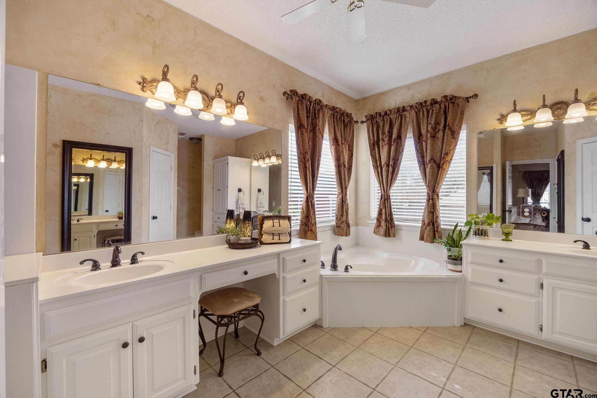 18344 Springmill Court Flint, TX 75762 - Photo 24 of 45 a bathroom with a double vanity sink mirror and bathtub