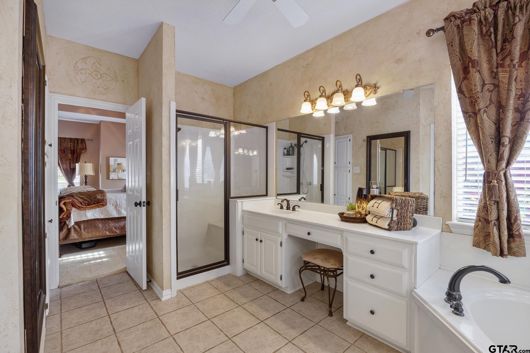 18344 Springmill Court Flint, TX 75762 - Photo 27 of 45 a en suite spacious bathroom with a double vanity sink and a mirror