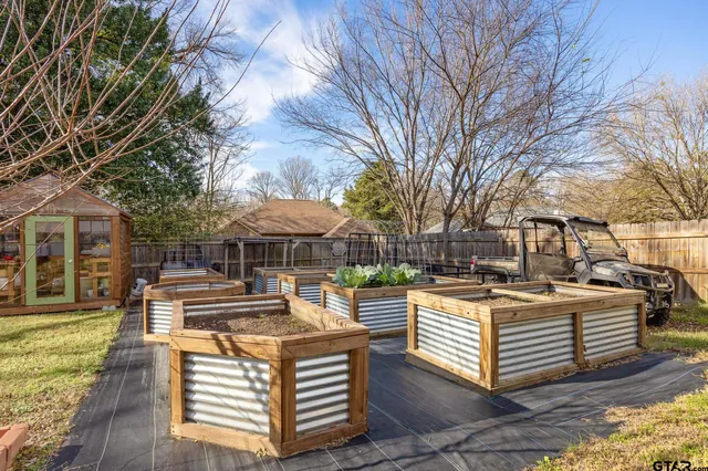 a view of a white house with a big yard and large trees