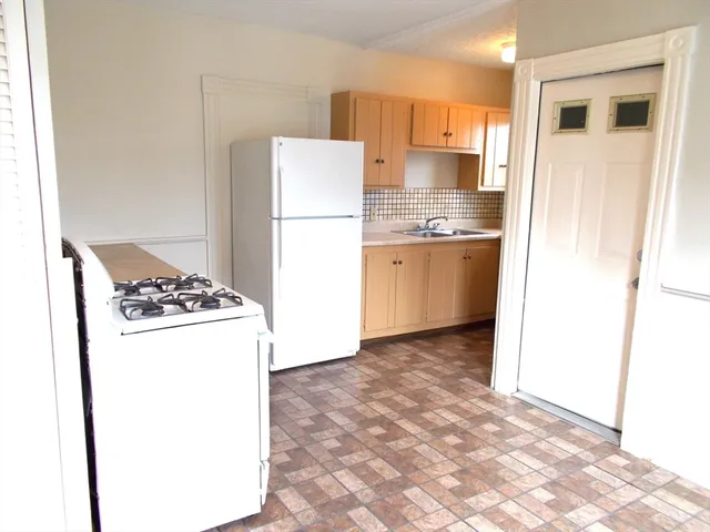 a kitchen with a refrigerator and a stove