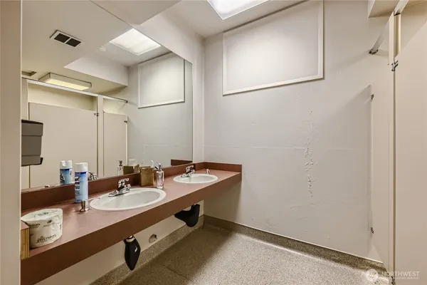 a bathroom with a double vanity sink and a mirror