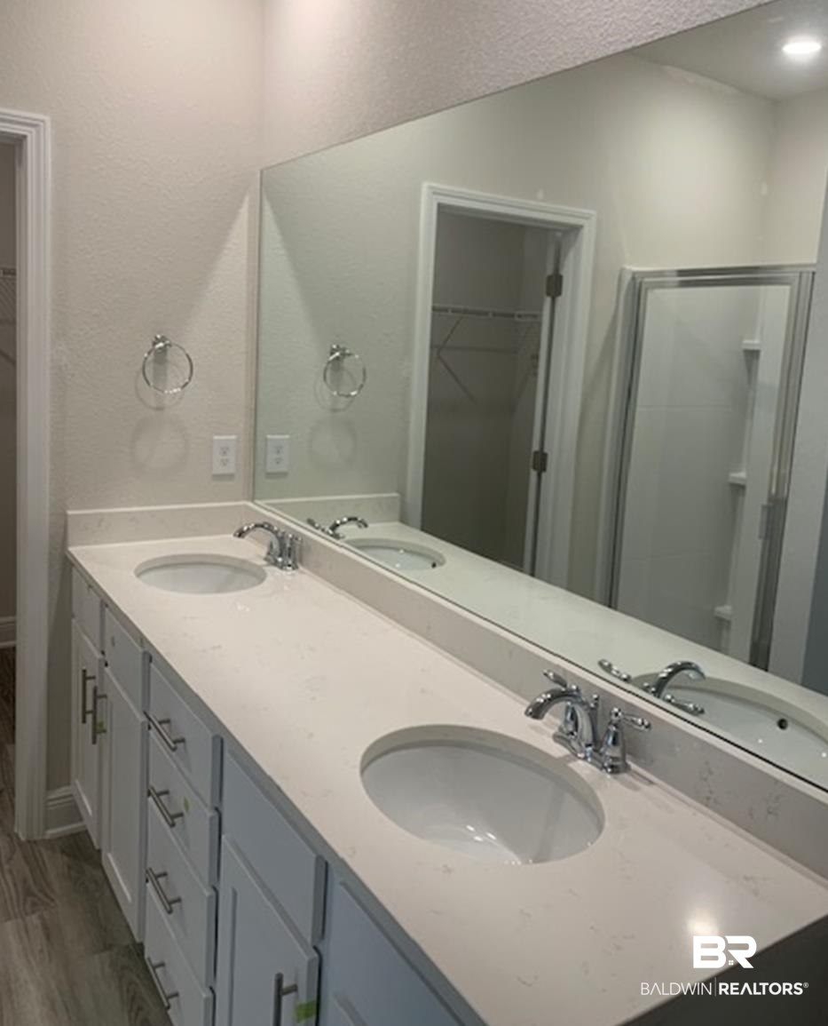 12904 Grand Rpds Road Fairhope, AL 36532 - Photo 22 of 34 Bathroom with hardwood / wood-style floors, a shower with door, vanity, and a textured ceiling