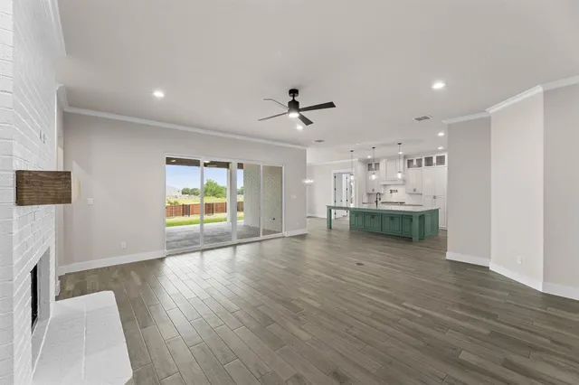 a large kitchen with kitchen island a sink stainless steel appliances and cabinets