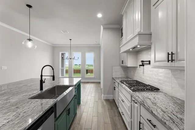 a kitchen with stainless steel appliances granite countertop a stove and a microwave