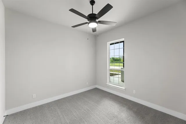 a view of room with window and ceiling fan