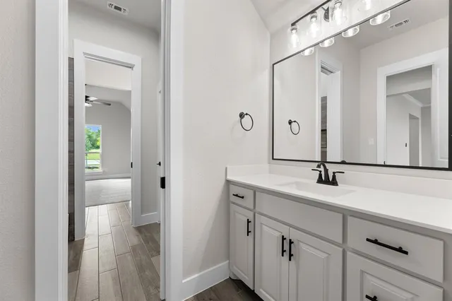 a bathroom with a double vanity sink and mirror with shower