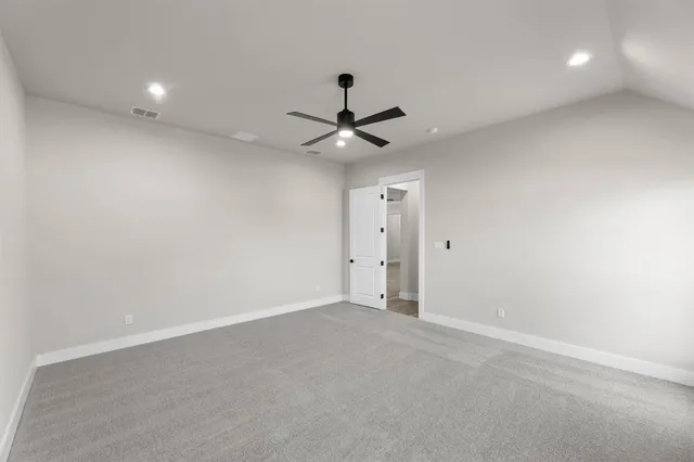 a bathroom with a granite countertop sink a mirror a shower and vanity