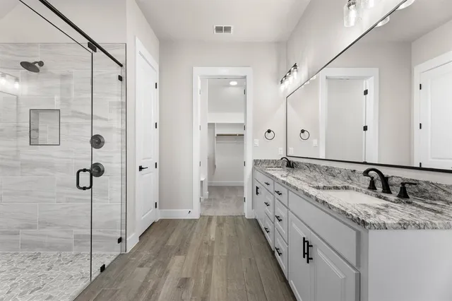 a bathroom with a granite countertop sink mirror and double