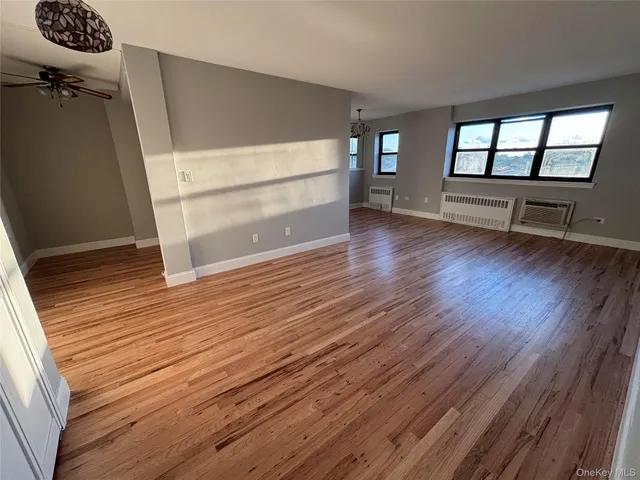 a view of walk in closet with wooden floor and stairs