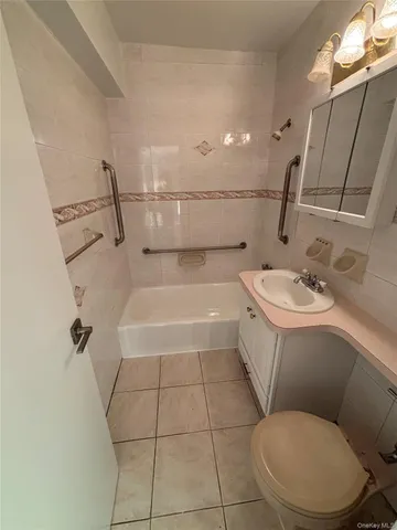 a view of an empty room with wooden floor and windows