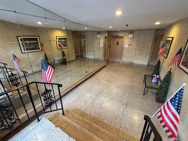 a lobby with furniture and a rug