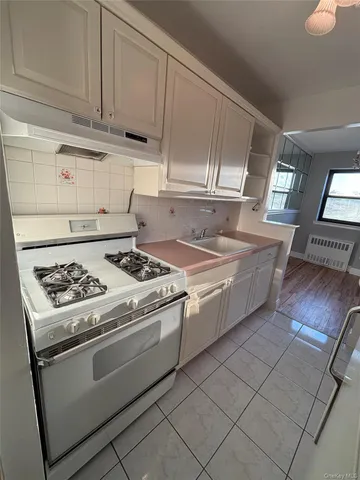 a kitchen with cabinets a sink and appliances