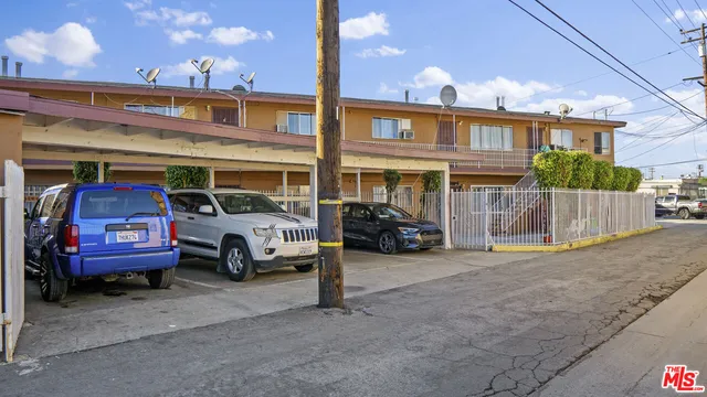 a view of a car is parked in front of a building