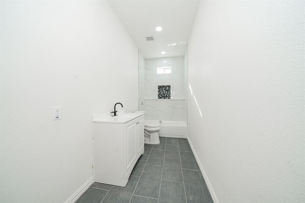 373 5th Street Northwest Paris, TX 75460 - Photo 12 of 16 a bathroom with a sink and a mirror