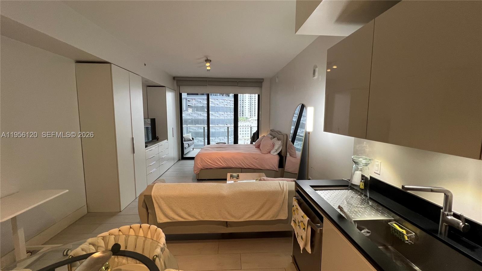 1010 Brickell Avenue, Unit 1510 Miami, FL 33131 - Photo 7 of 32 a bedroom with a bed and wooden floor