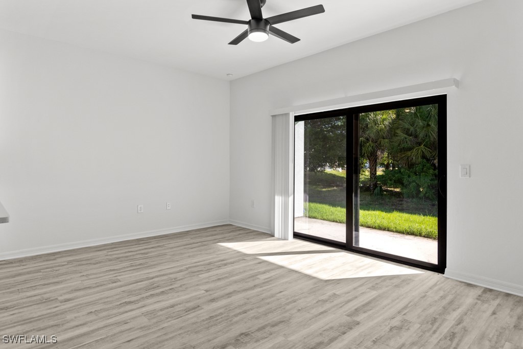1121 Abrams Boulevard Lehigh Acres, FL 33971 - Photo 29 of 43 a view of an empty room with wooden floor and a window