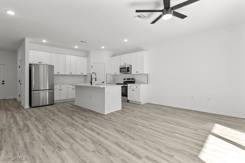 1121 Abrams Boulevard Lehigh Acres, FL 33971 - Photo 33 of 43 a view of kitchen with wooden floor