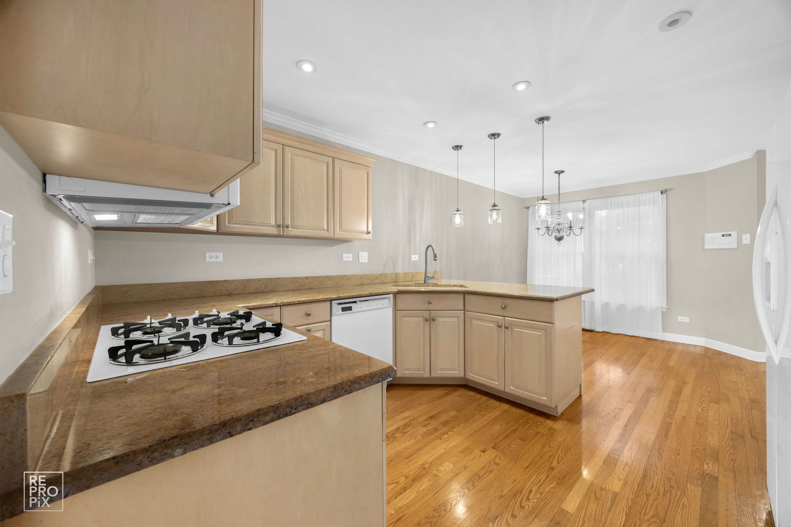 536 West Evergreen Street Wheaton, IL 60187 - Photo 3 of 17 a kitchen with granite countertop a stove a sink dishwasher and white cabinets with wooden floor