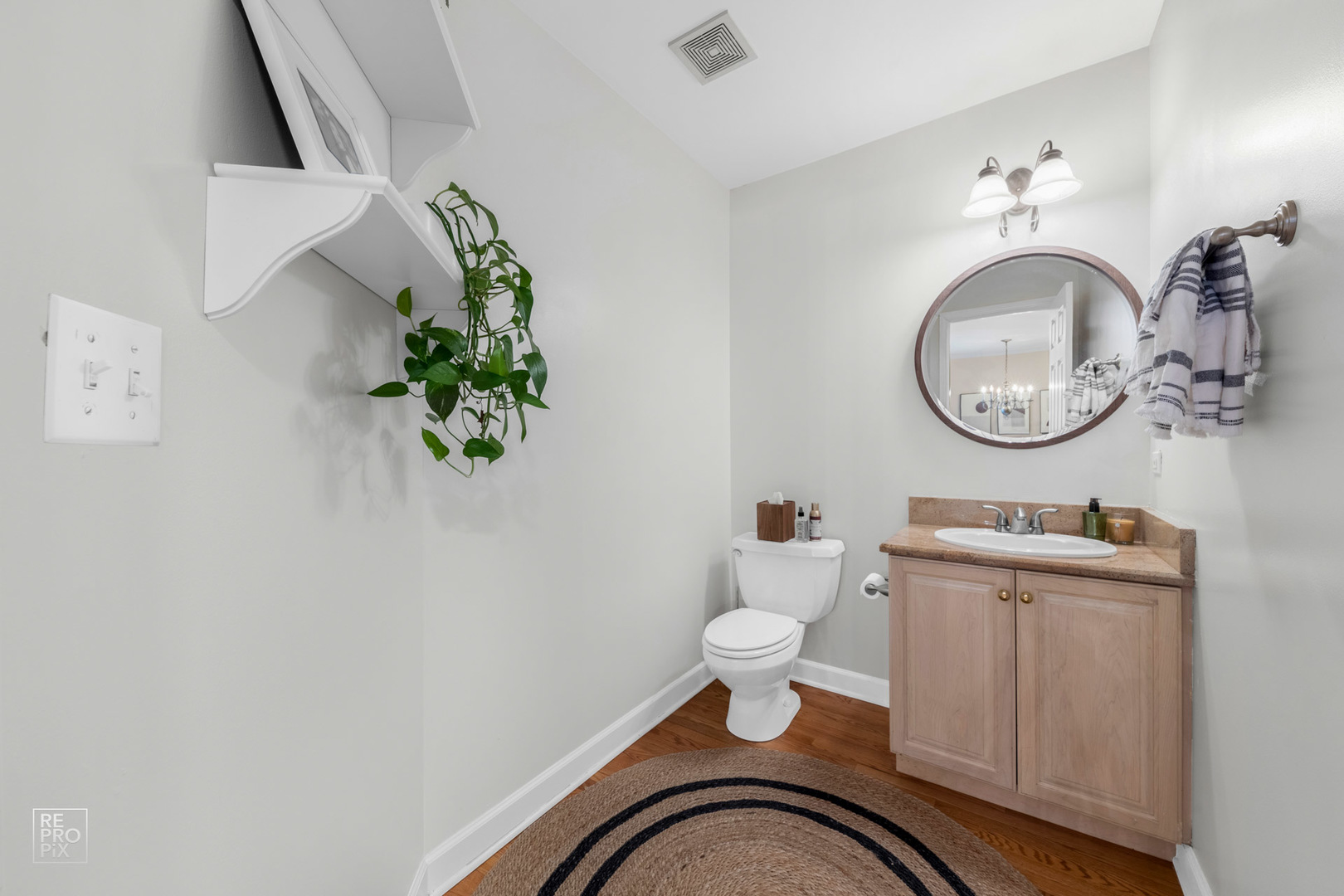 536 West Evergreen Street Wheaton, IL 60187 - Photo 7 of 17 a bathroom with a toilet a sink and mirror