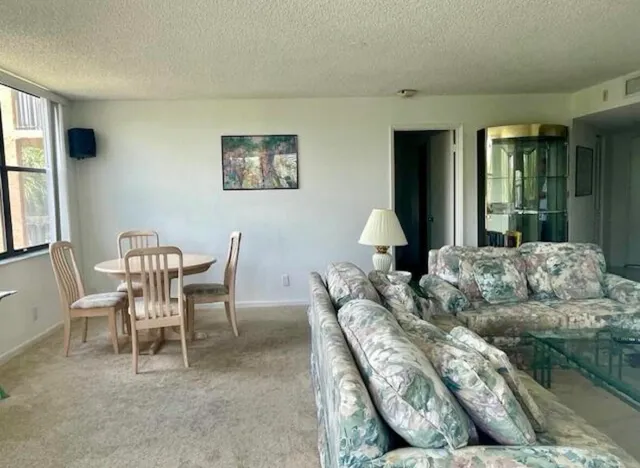a view of a dining room with furniture window and outside view