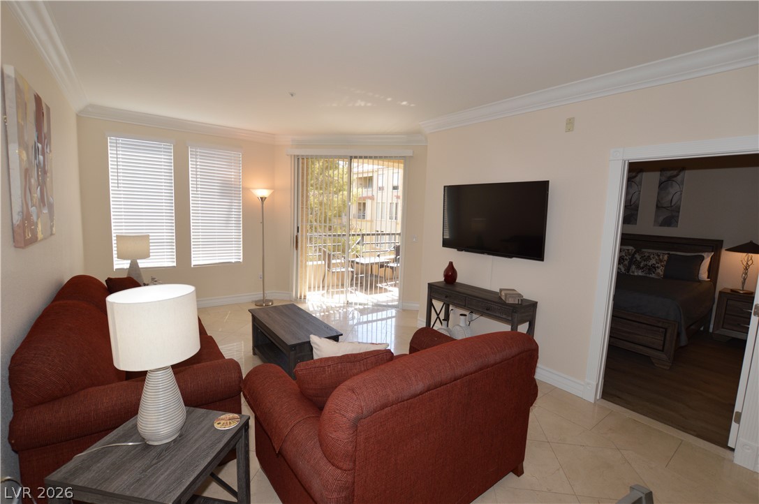 230 East Flamingo Road, Unit 334 Las Vegas, NV 89169 - Photo 2 of 37 Polished tile flooring and elegant crown molding elevate this open living area.